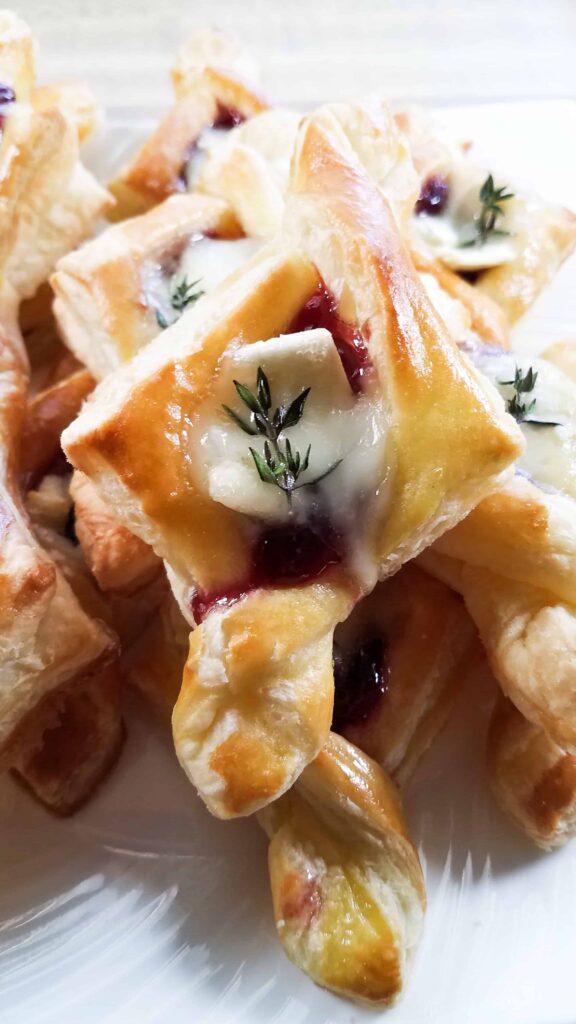 A plate of delicious raspberry brie tarlets. A perfect holiday party appetizer!