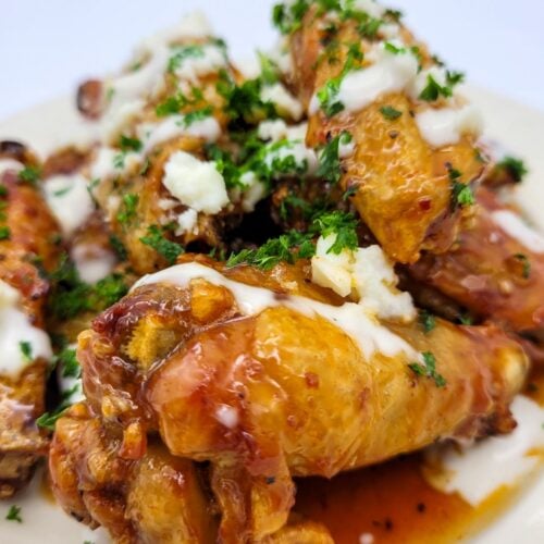 A view from the front of hot honey chicken wings prepared in an air fryer.