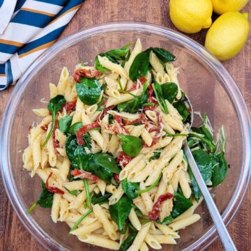 A large bowl of sun-dried tomato pasta salad