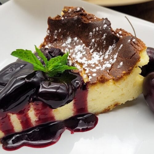 A slice of Basque cheesecake with cherry rioja sauce.