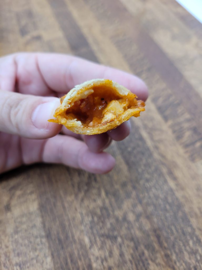 Oven pizza roll with a bite taken out