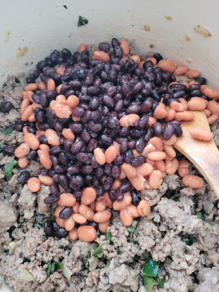 Adding black beans and pinto beans to chili in Dutch oven