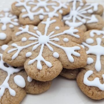 A close up of gingerbread cookies decorated with royal icing