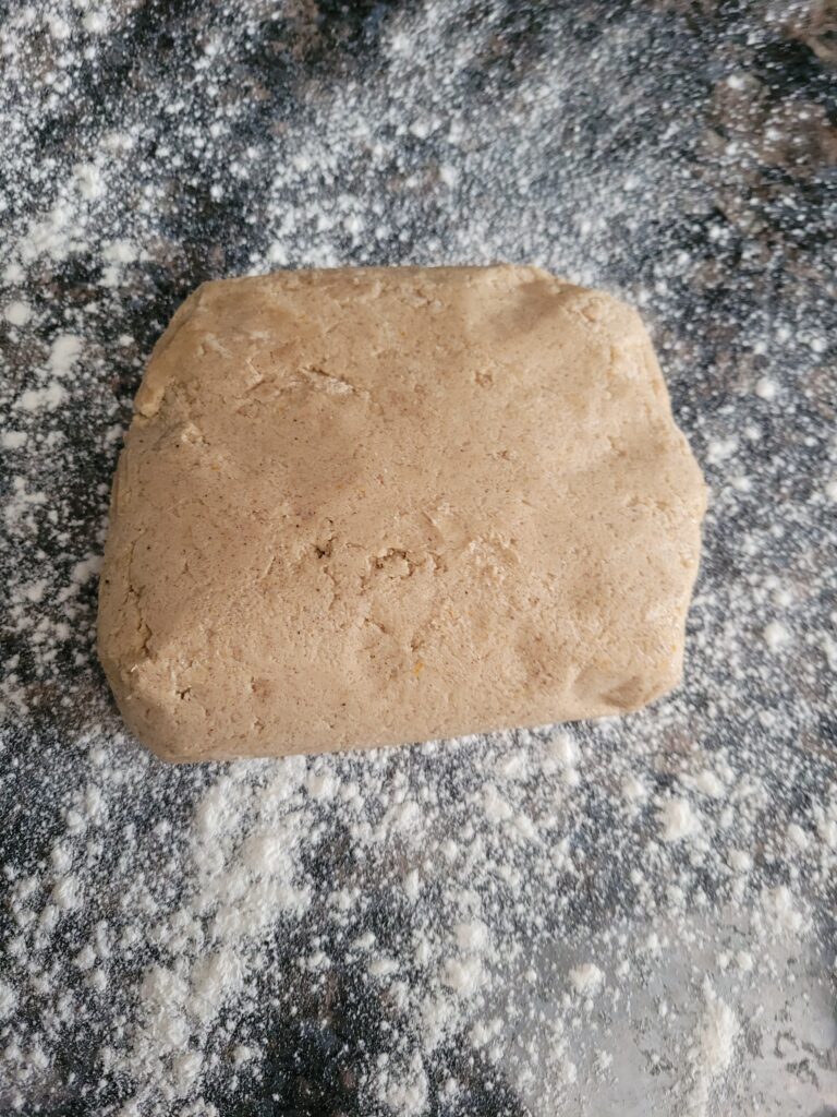 Gingerbread cookie dough on a floured surface